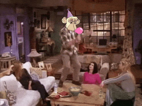 a man in a party hat is blowing a pink bubble