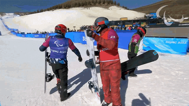 a snowboarder wearing a purple vest with the number 21 on it