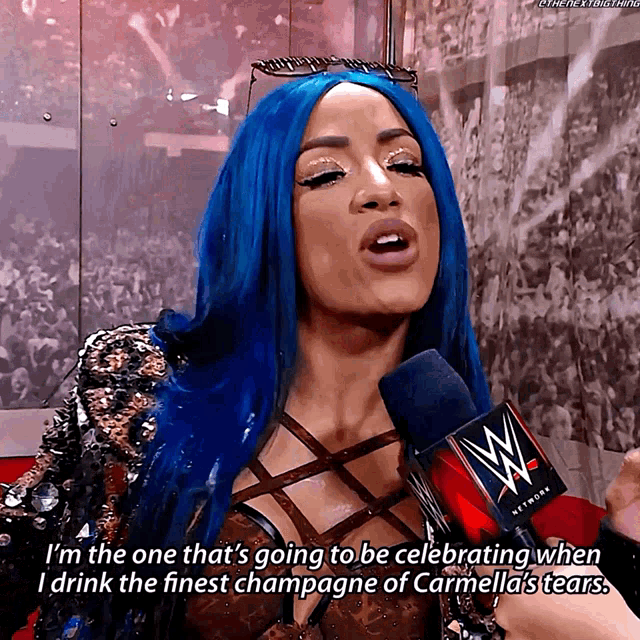 a woman with blue hair is talking into a microphone with a wwe logo