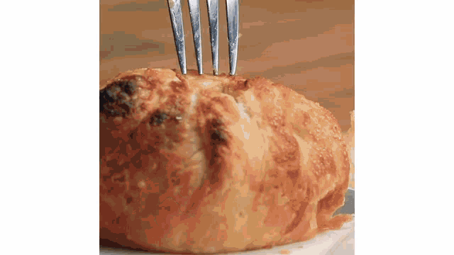 a close up of a piece of bread with a fork sticking out of it .
