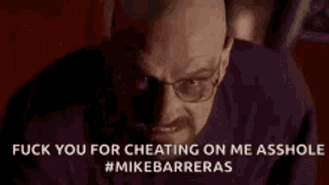 a man with glasses is holding his finger to his forehead .