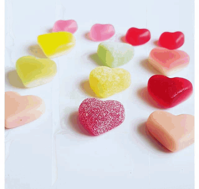 a box filled with different types of candy including heart shaped marshmallows