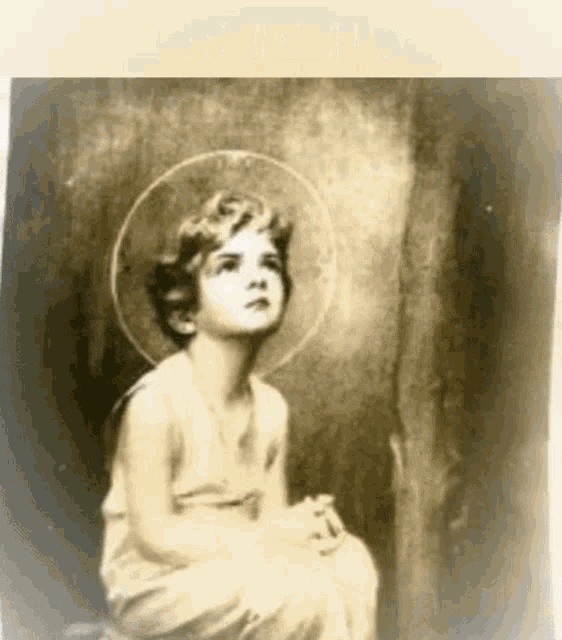 a black and white photo of a little girl wearing a halo .