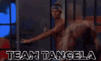 a man and a woman are dancing in front of a sign that says " team tangela "