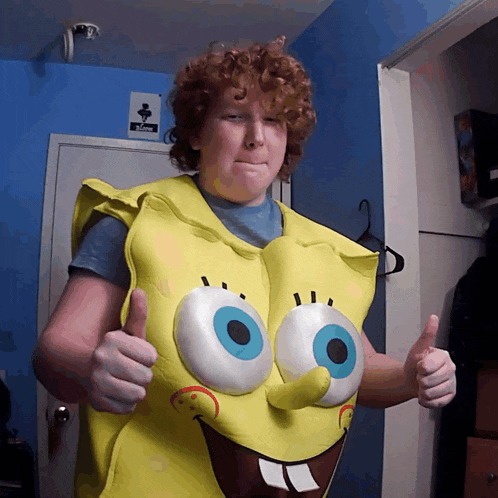 a boy wearing a spongebob costume giving a thumbs up
