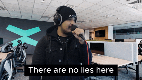 a man singing into a microphone with the words " there are no lies here " on the bottom