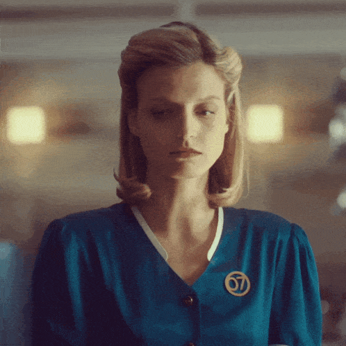 a woman wearing a blue shirt with the number 07 pin