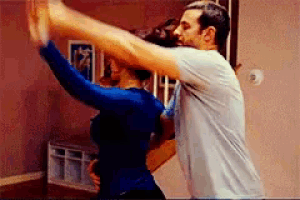 a man and a woman are dancing in a dance studio .