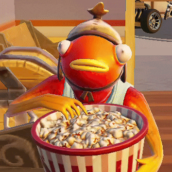 a fish is holding a bowl of popcorn in his hand