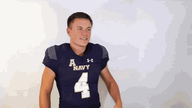 a young man wearing a navy jersey with the number 4 on it