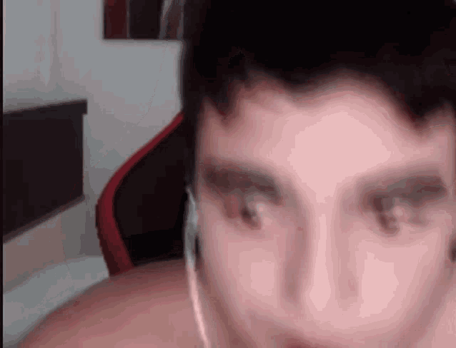 a close up of a man wearing headphones while looking at the camera .