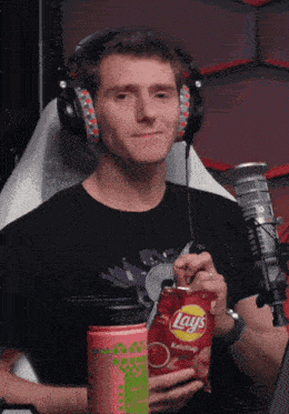 a man is holding a bag of lays ketchup