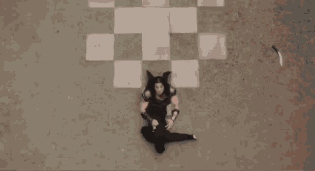 a woman in a warrior costume is laying on the ground