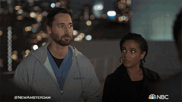 a man and a woman are standing next to each other and the hashtag #newamsterdam