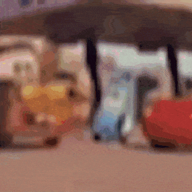 a blurry picture of a building with a red car in front of it