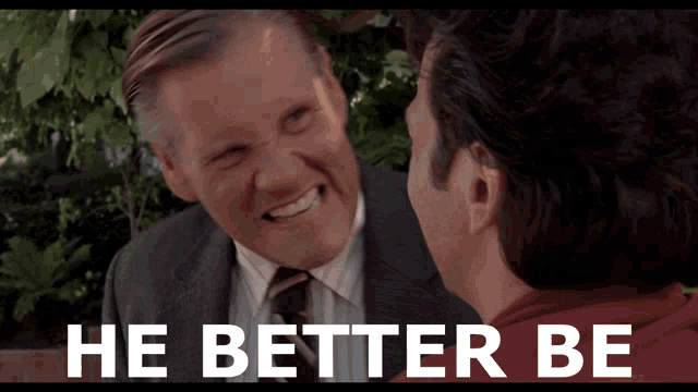 a man in a suit and tie smiles next to another man with the words he better be on the bottom
