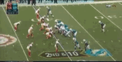 a blurry picture of a football game being played on a field .