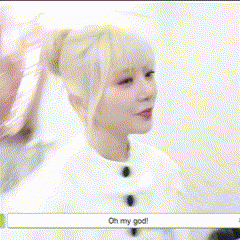a woman with blonde hair is smiling in a room with korean writing on the bottom