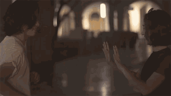 a man and woman are giving each other high fives
