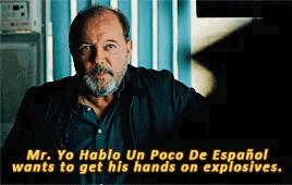 a man with a beard and mustache is talking to another man in a movie .