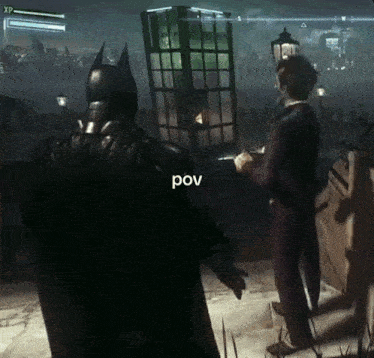batman and the joker are playing a video game and the joker is holding a gun