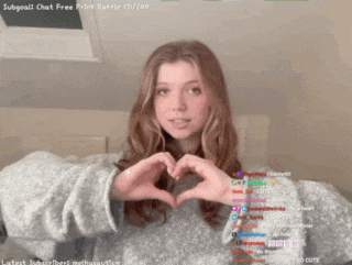 a girl making a heart shape with her hands on a screen that says subgoal2 chat free print raffle