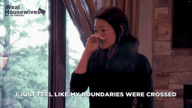 a woman wipes her nose in front of a window and says ' i just feel like my boundaries were crossed '