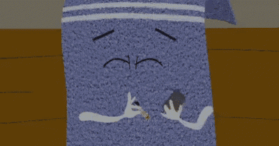 a purple towel with white eyes and a hand making a peace sign