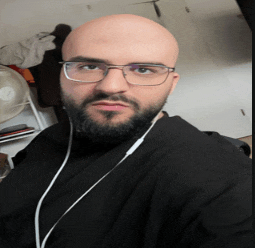 a bald man with a beard wearing glasses