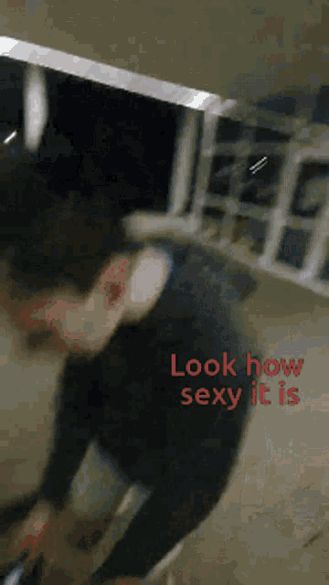 a blurred image of a man with the words look how sexy it is on the bottom