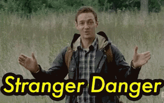a man in a plaid shirt is standing in a field with the words " stranger danger " written above him