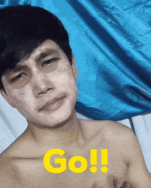 a shirtless man with the word go written in yellow on his chest