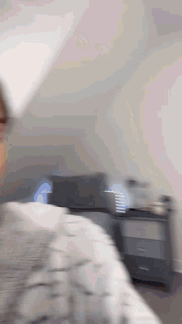 a blurry picture of a person standing in front of a dresser