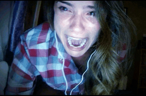 a woman in a plaid shirt is wearing headphones