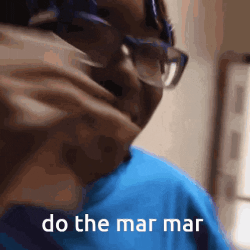 a man wearing glasses and a blue shirt is saying do the mar mar