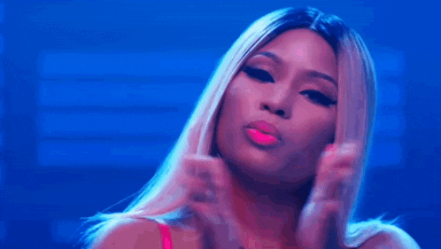 a close up of a woman 's face with a blue background and a pink lip .