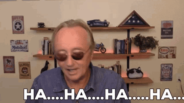 a man wearing sunglasses says " ha ha ha ha "