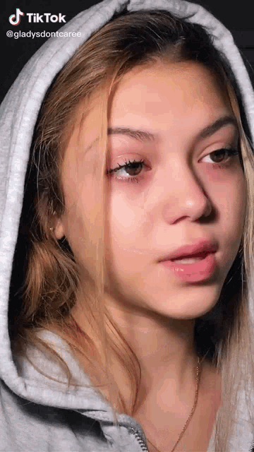 a close up of a girl 's face with a tiktok watermark on the bottom