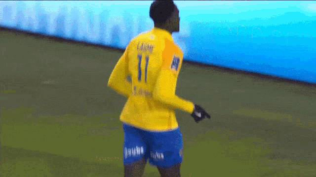 a man in a yellow jersey with the number 11 on it