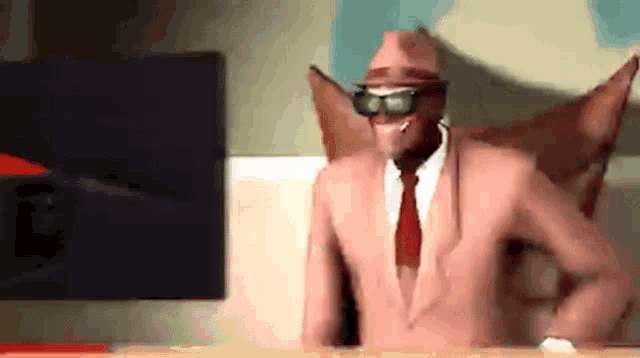 a man in a pink suit and red tie is dancing