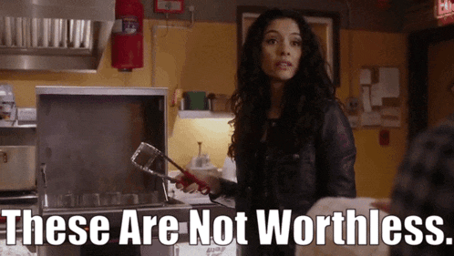 a woman in a kitchen holding a spatula with the words " these are not worthless " below her