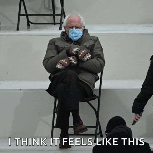a man wearing mittens and a mask is sitting in a chair with the words " i think it feels like this " below him