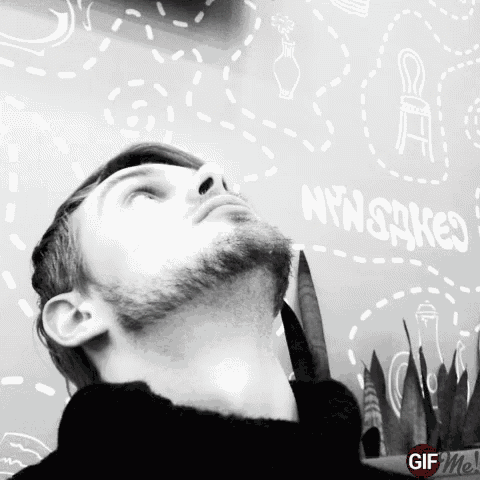 a man with a beard looks up at a wall that says nyworks