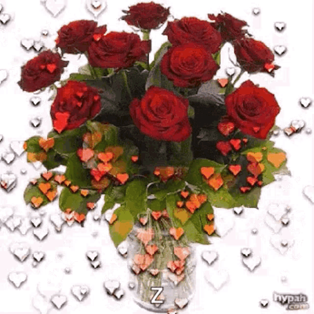 a bouquet of red roses in a vase with hearts around them