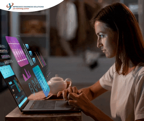 a woman is typing on a laptop in front of an advertisement for impressco business solutions