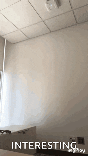 a room with a white wall and a ceiling that says interesting