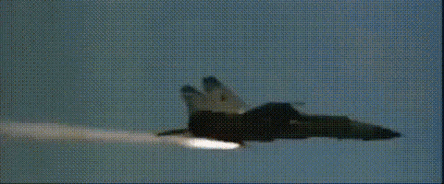 a fighter jet is flying through a cloudy sky in a blurry photo .