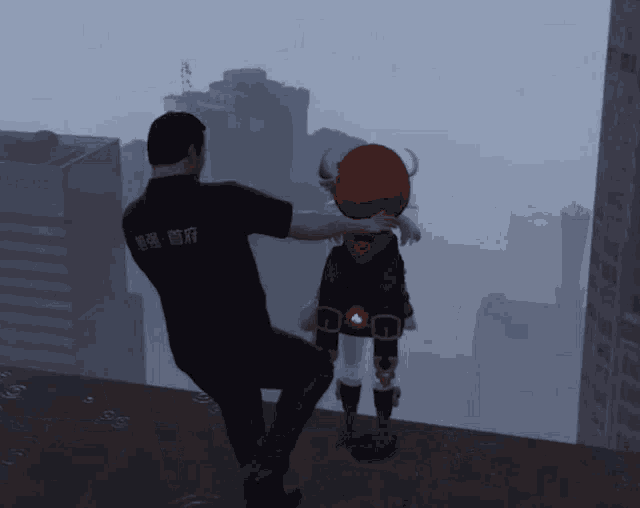 a man in a black shirt with chinese writing on the back holds a girl with horns