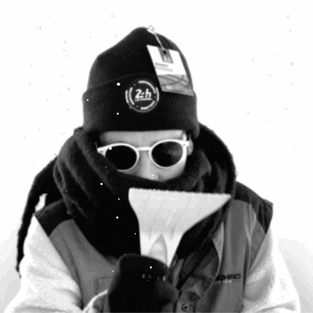 a black and white photo of a person wearing sunglasses and a beanie that says 24h