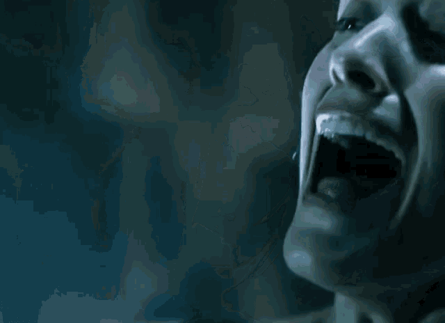 a close up of a woman with her mouth open
